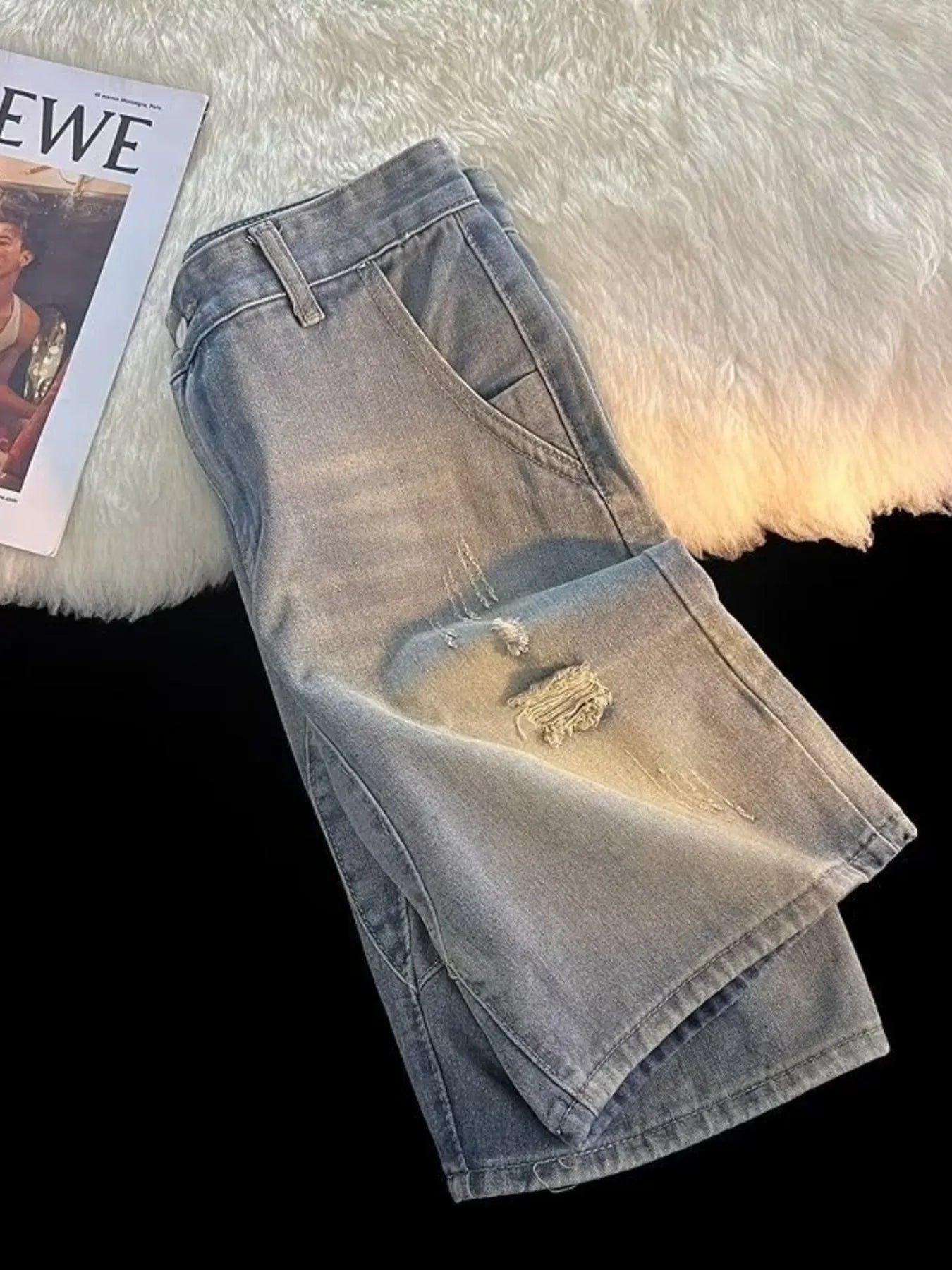 Light blue ripped denim jeans for men on fur surface, streetwear style