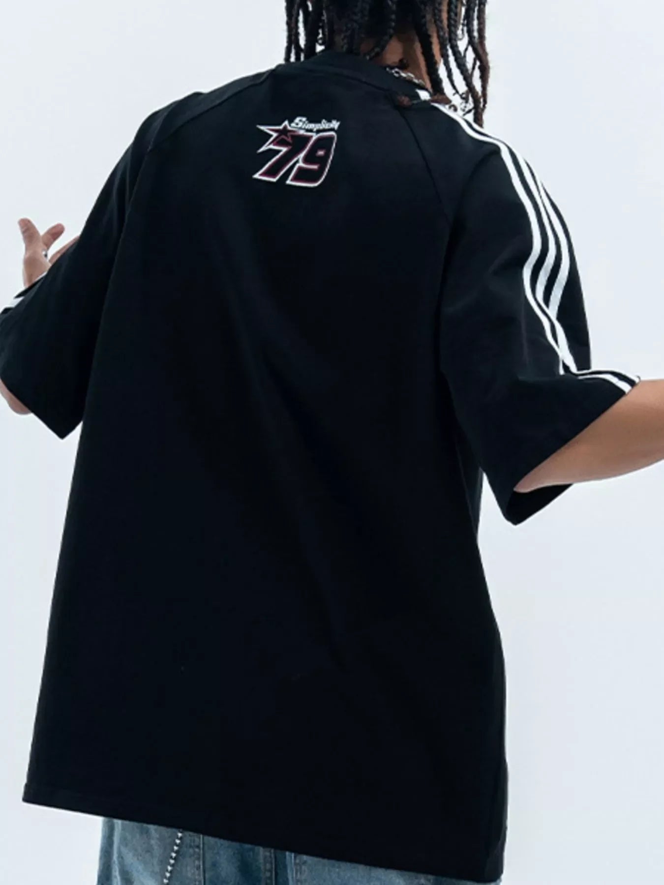 Oversized black streetwear t-shirt with white stripes, graphic print '79' on back, men's fashion