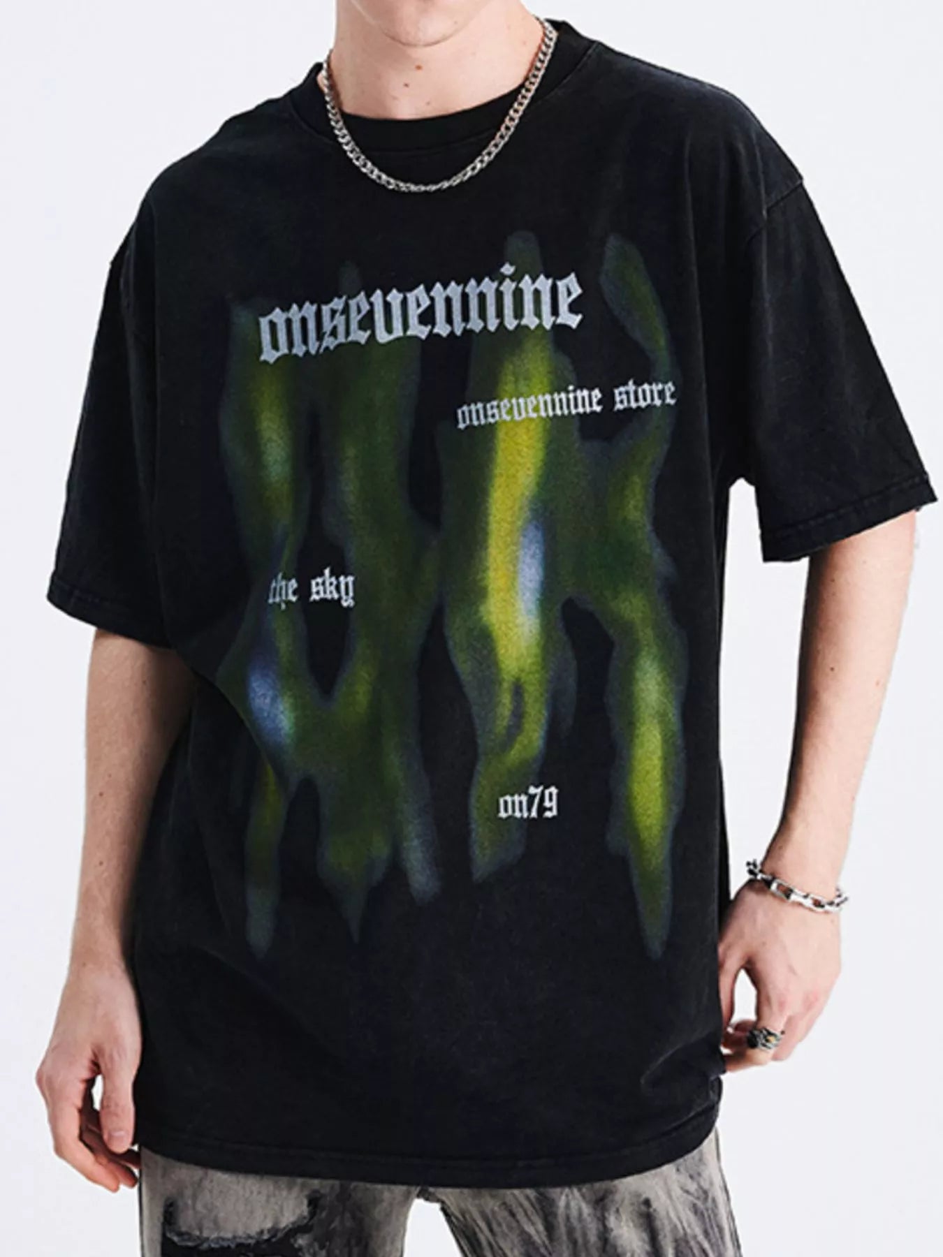 Oversized graphic streetwear t-shirt for men with green graffiti-style print and urban lettering