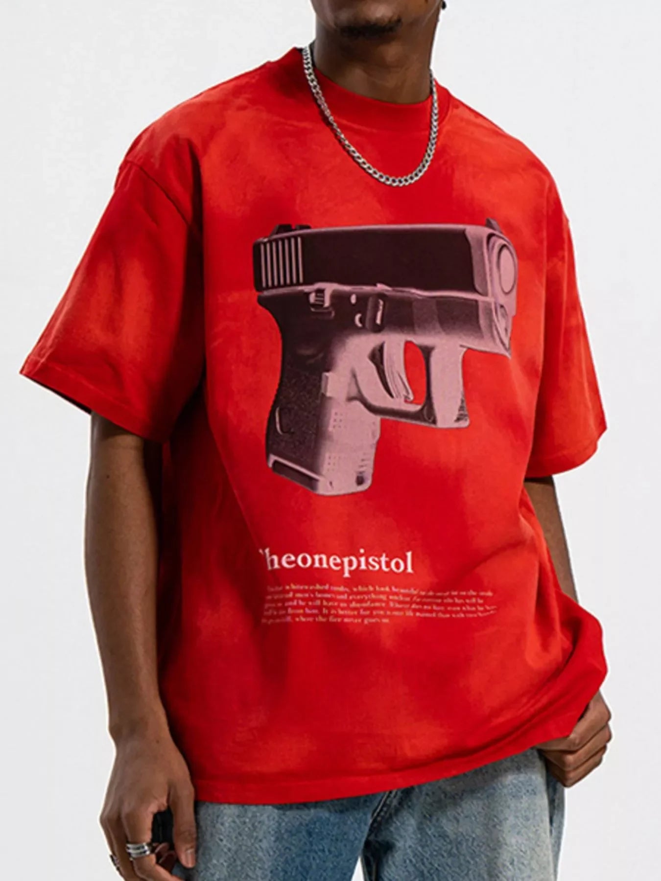 Man wearing oversized red streetwear t-shirt with large graphic print and chain necklace