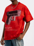 Man wearing oversized red streetwear t-shirt with gun graphic, urban fashion style